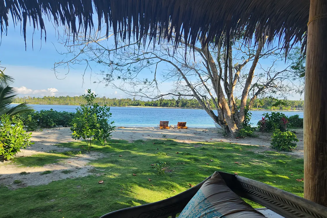 Perfect Hideaways real estate property: A four-poster bed with a mosquito net, featuring a doorway to the garden. Leleu Boutique Beach Villas, Mentawai.