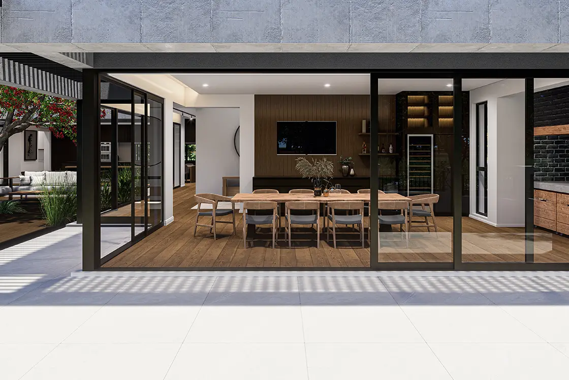 Perfect Hideaways property for sale: Modern dining room with a long wooden table and chairs, seen through large glass doors. The room is bright, airy, and elegantly decorated. Coral Tree House, Paarl.