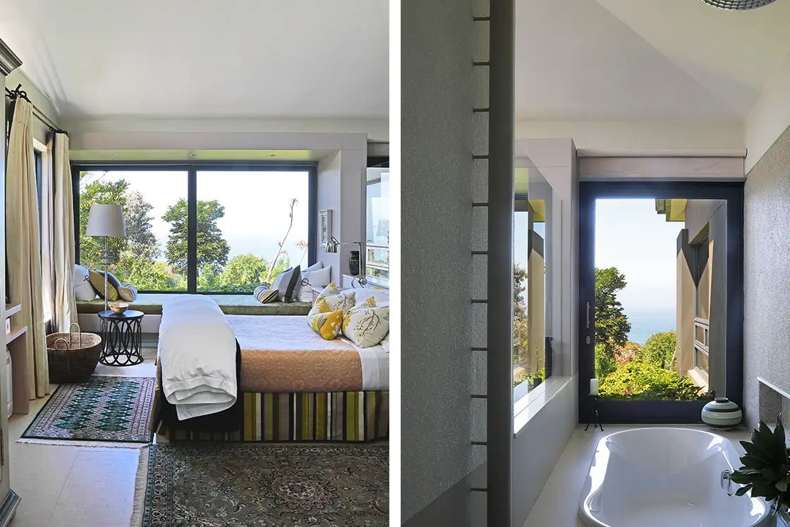 Perfect Hideaways real estate property: A cozy bedroom and bathroom with large windows offering views of lush greenery and the sea. The room has light tones, soft textiles, and a serene atmosphere. Knysna, Ocean’s Edge.